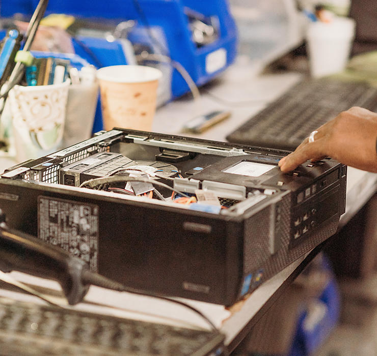 Dismantling an old piece of electronic equipment, inside a workshop