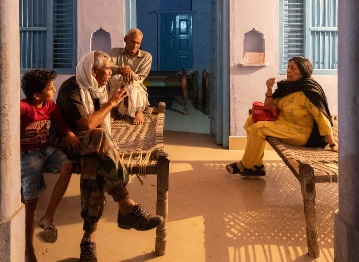 The author talking people while sitting in a courtyard