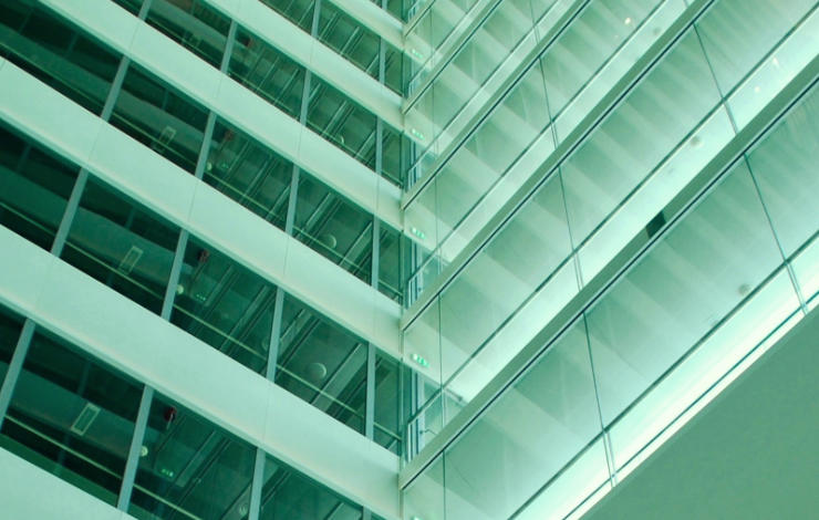 Tight shot, in perspective, of a steel and glass building facade