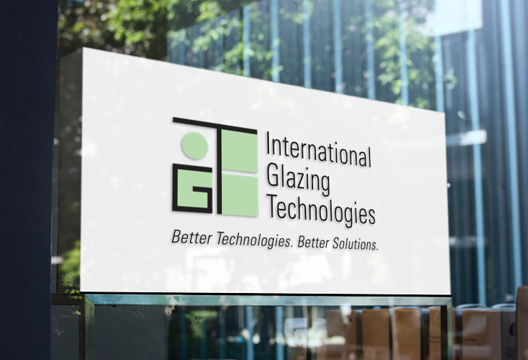 IGT logo fabricated and installed on the reflective glass of a modern office building