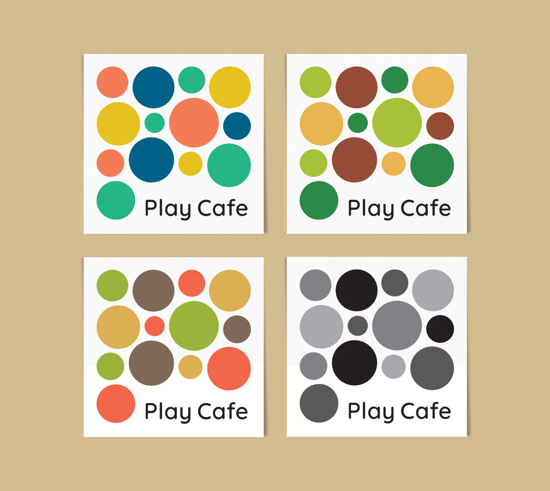 Four square coasters featuring bold dots in the four respective colour schemes with 'Play Cafe' placed below