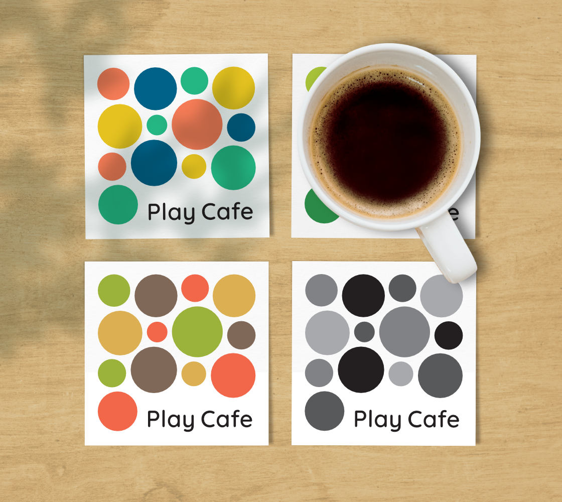 Four Play Cafe coasters with a cup of coffee placed on one of them