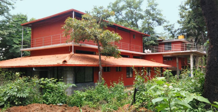 SARA Centre exterior — two storey building painted in red, amidst natural vegetation