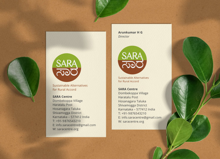 Two business cards along with some leaves on a natural background