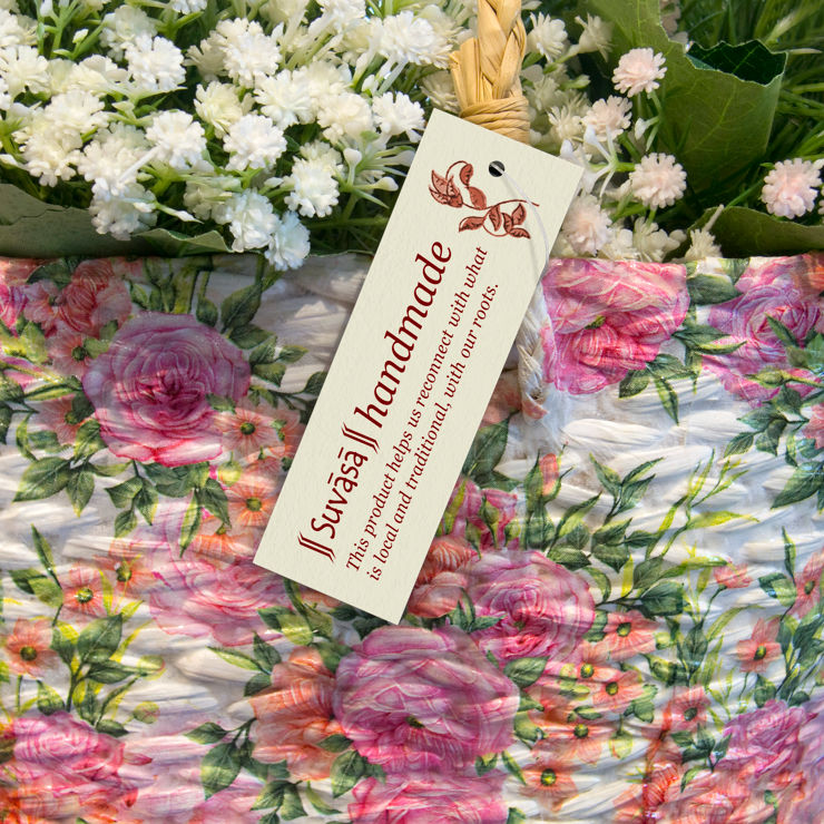 The tag hanging from a beautiful basket with floral motifs
