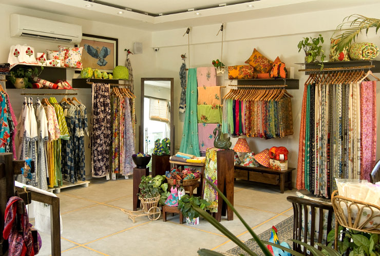 Colourful clothing and furnishing items displayed on shelves and stands