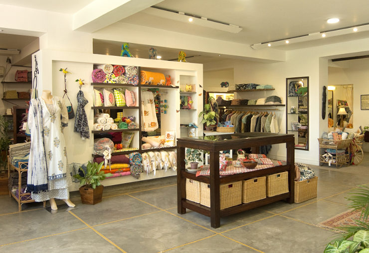 Clothing and furnishing items in shelves and on stands