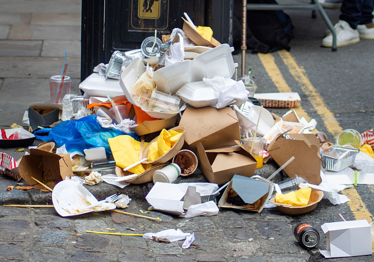 A pile of food and packaging waste / litter on a pavement