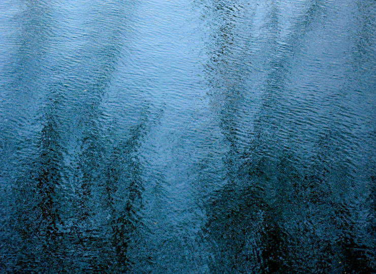 Fine art photograph of water in cyan and black colors, like a minimalistic, abstract oil painting