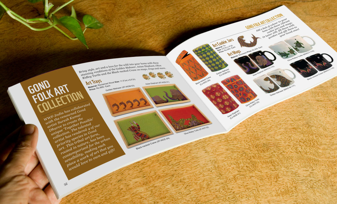 Printed catalogue on a table, revealing a spread with Gond folk art collection