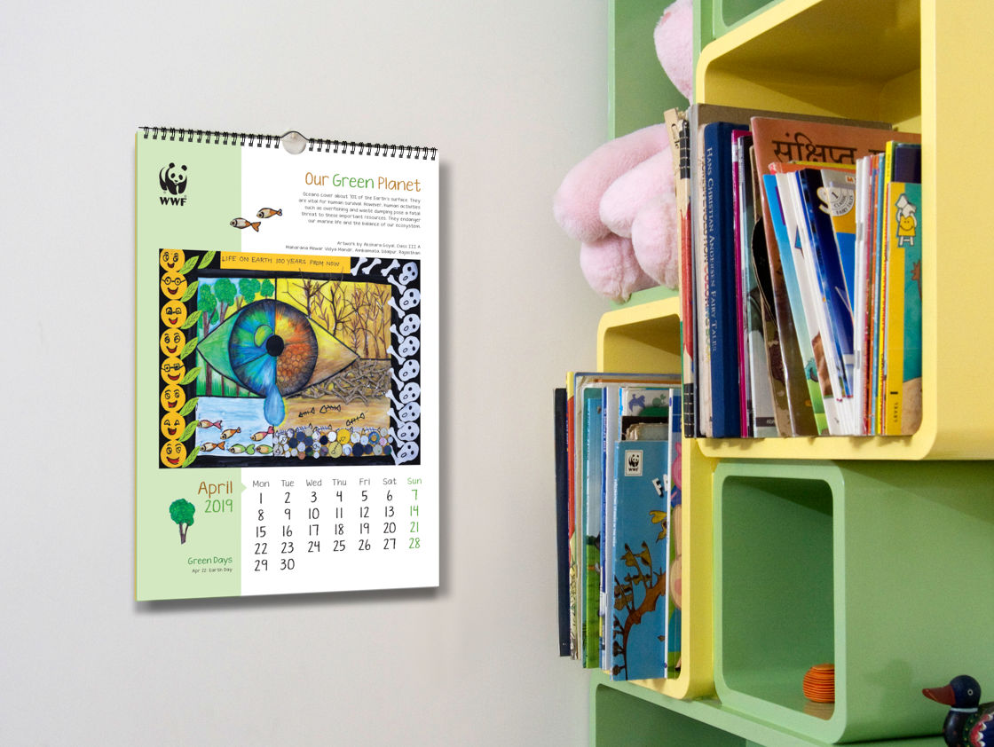 The calendar hanging on a wall beside a colourful book rack